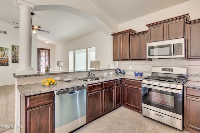 kitchen with decorative columns, appliances with stainless steel finishes, lofted ceiling, ceiling fan, and kitchen peninsula