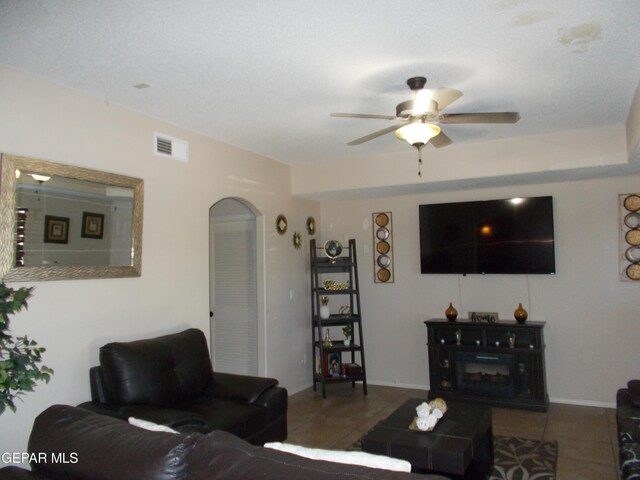 tiled living room featuring ceiling fan