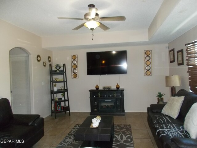 living room featuring tile patterned floors and ceiling fan