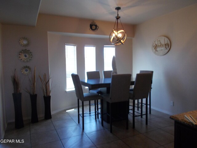 dining space featuring a chandelier and tile patterned flooring