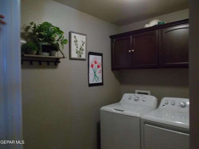 laundry room featuring cabinets and separate washer and dryer