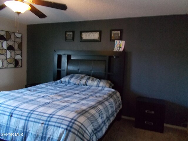 bedroom featuring ceiling fan and carpet