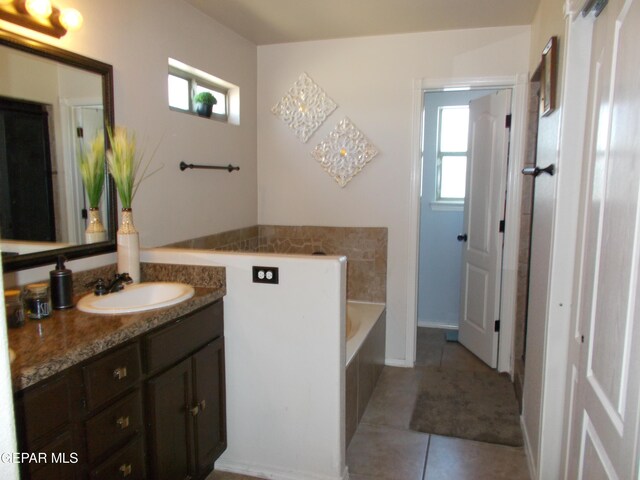 bathroom featuring a washtub, vanity, and tile patterned floors