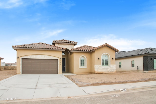 mediterranean / spanish-style house with a garage