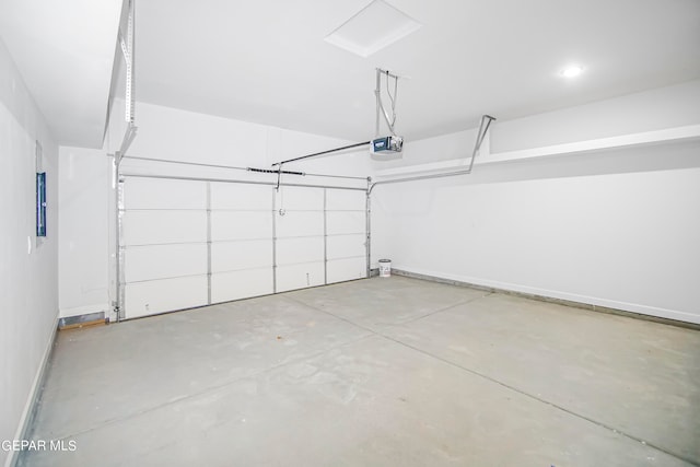 garage featuring electric panel and a garage door opener