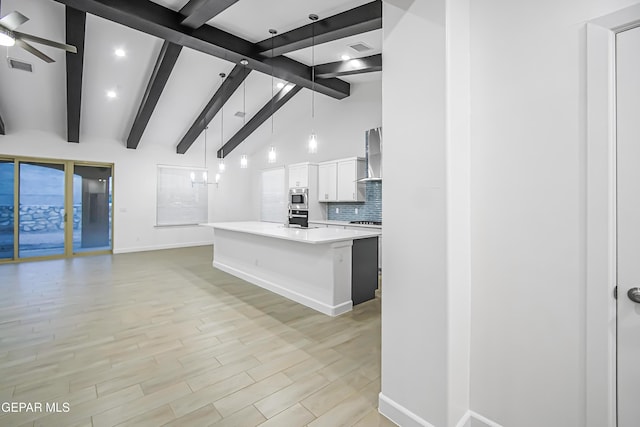 kitchen featuring a center island, stainless steel appliances, light hardwood / wood-style flooring, decorative light fixtures, and white cabinets