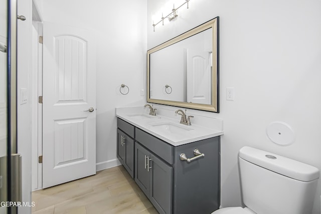 bathroom featuring vanity, wood-type flooring, and toilet