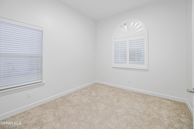 unfurnished room featuring light colored carpet