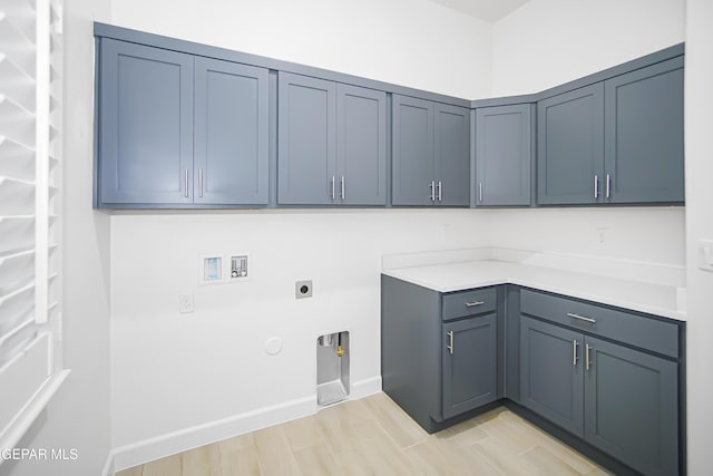 washroom with electric dryer hookup, cabinets, hookup for a gas dryer, hookup for a washing machine, and light hardwood / wood-style floors