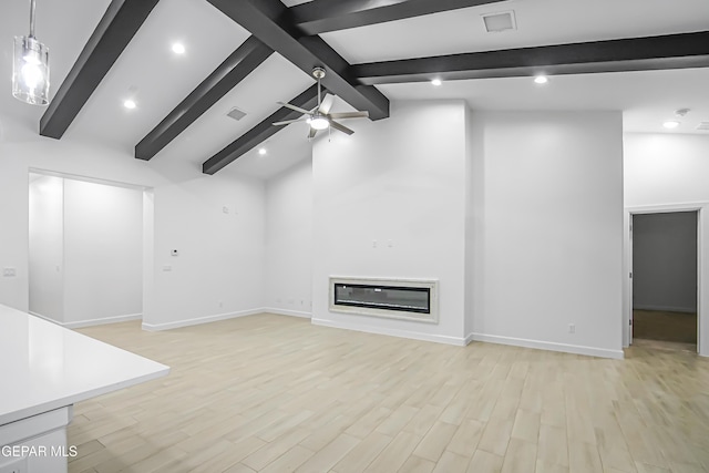 unfurnished living room with ceiling fan, beam ceiling, high vaulted ceiling, and light hardwood / wood-style flooring