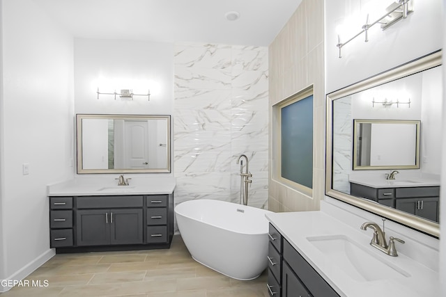 bathroom with vanity, a bath, and tile walls