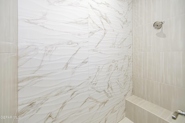 bathroom with tiled shower