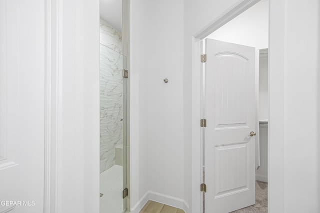 bathroom with a shower with shower door