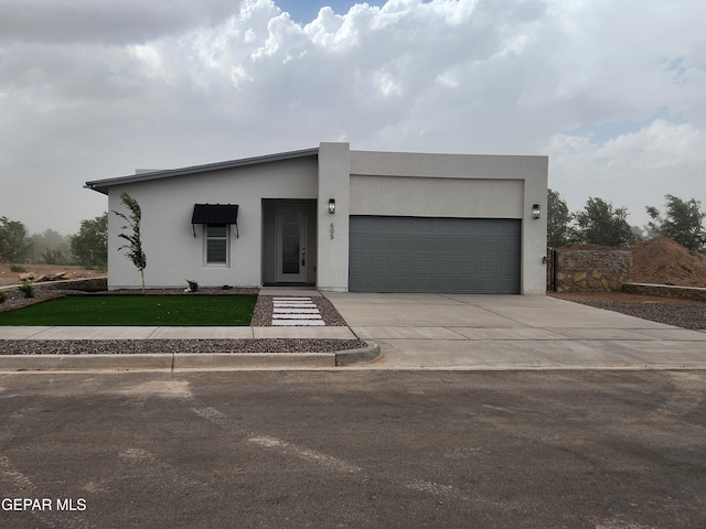 modern home with a front yard and a garage