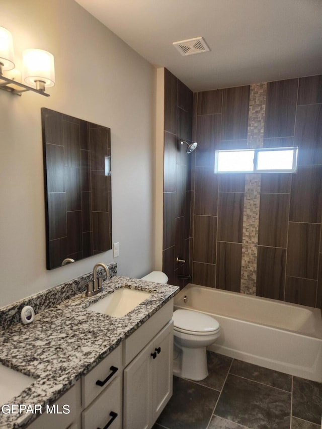 full bathroom with toilet, tile patterned floors, vanity, and tiled shower / bath combo