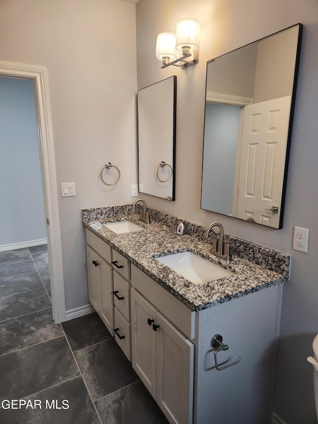 bathroom featuring dual bowl vanity and tile patterned floors