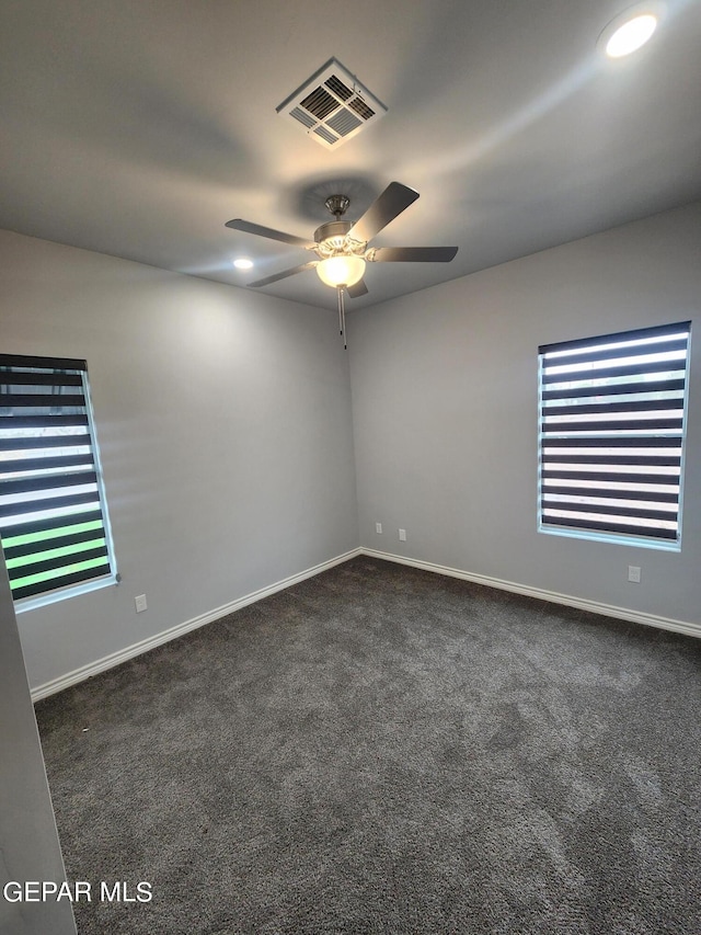 empty room with ceiling fan and carpet floors