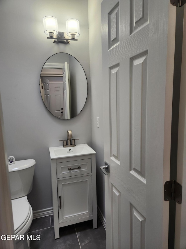 bathroom featuring vanity, tile patterned flooring, and toilet