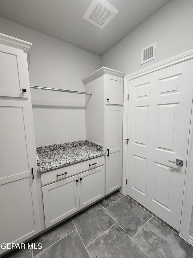 washroom with dark tile patterned flooring