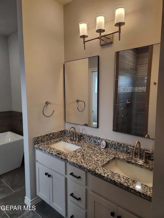 bathroom with dual bowl vanity, plus walk in shower, and tile patterned flooring