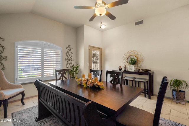 dining area with ceiling fan, lofted ceiling, and light tile patterned floors