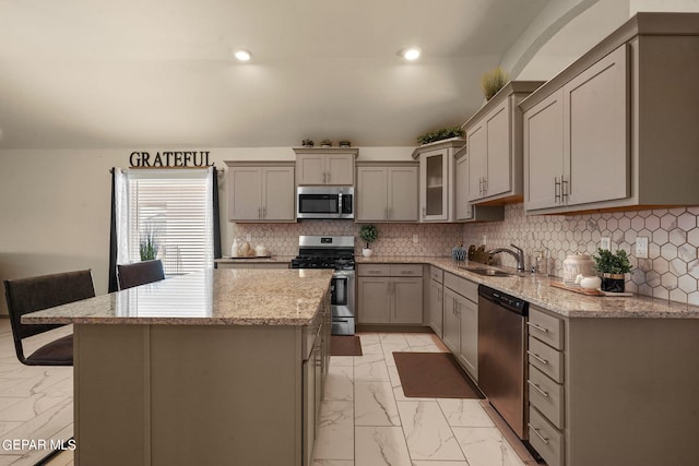 kitchen featuring appliances with stainless steel finishes, light tile patterned floors, gray cabinets, and sink