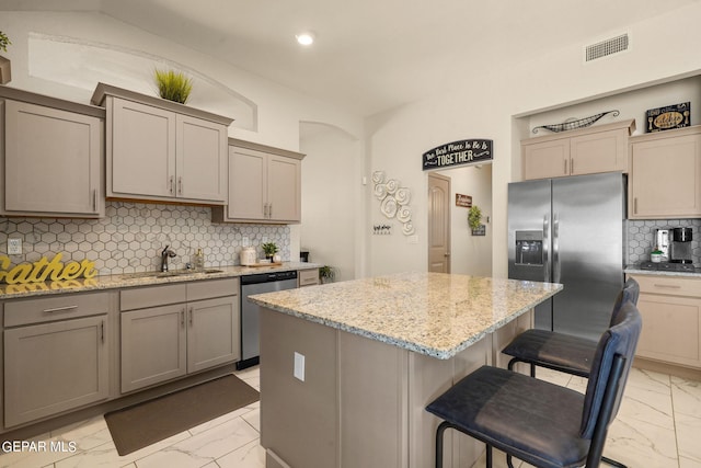 kitchen with sink, backsplash, appliances with stainless steel finishes, and light tile patterned flooring