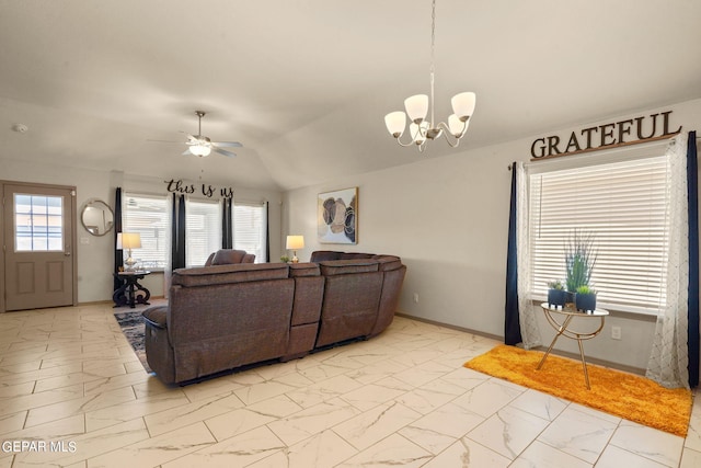 tiled living room with ceiling fan with notable chandelier and a healthy amount of sunlight