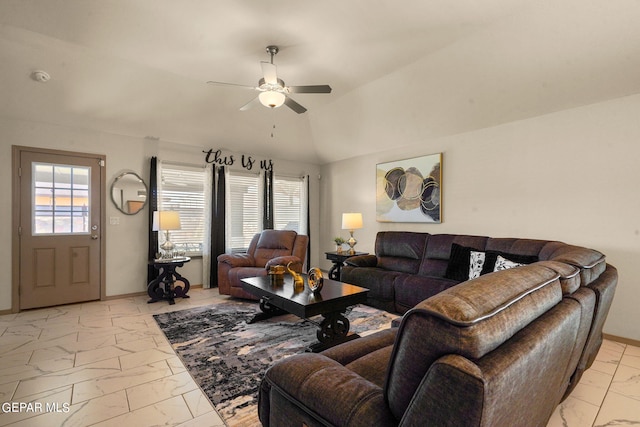 living room featuring ceiling fan, vaulted ceiling, and light tile patterned floors