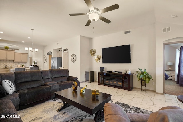 carpeted living room with ceiling fan, vaulted ceiling, and sink