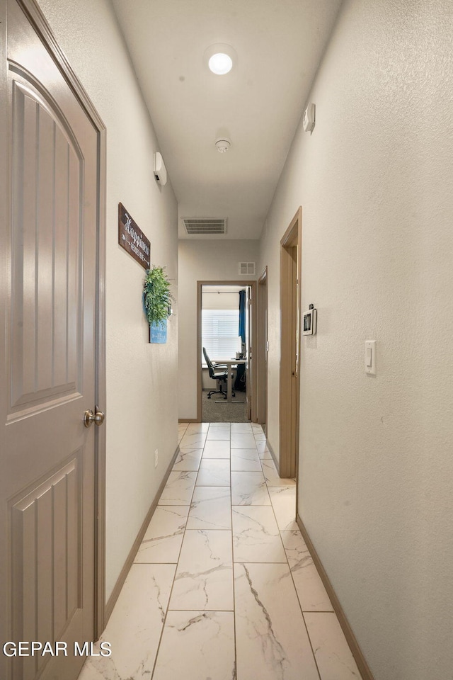 corridor featuring light colored carpet