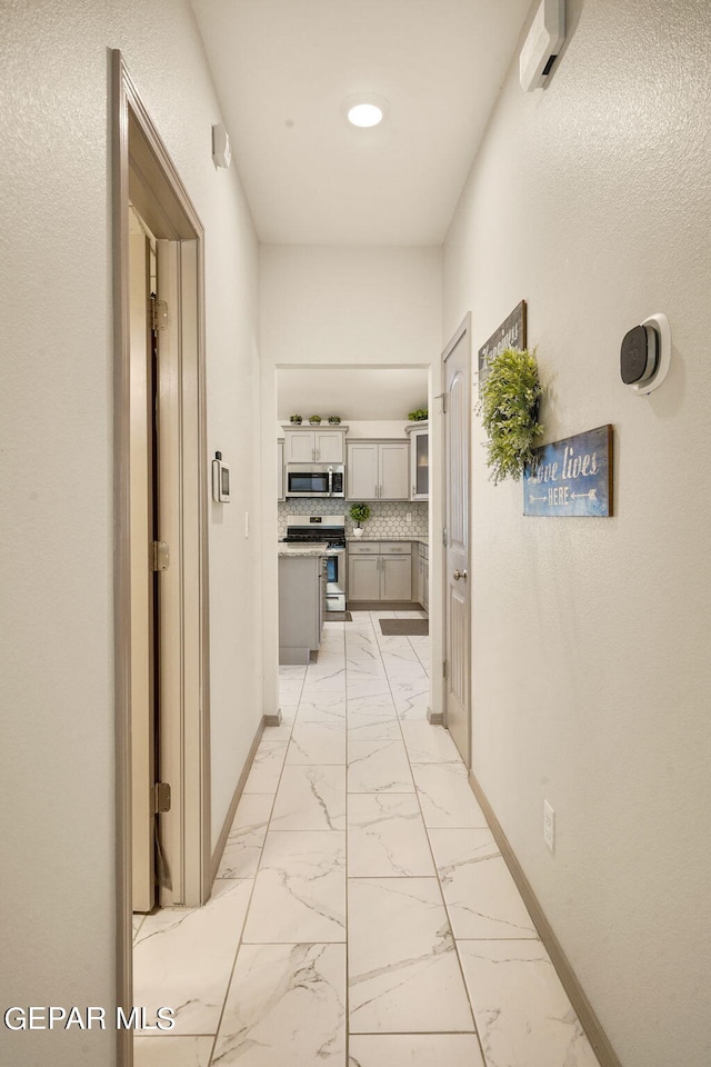 hall with light tile patterned floors