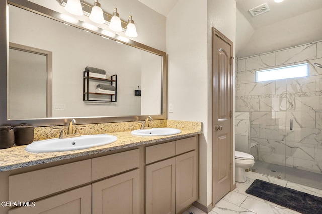 bathroom featuring tile patterned floors, double sink vanity, walk in shower, and toilet