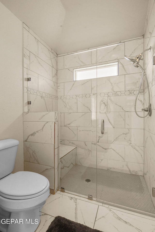 bathroom featuring tile patterned floors, an enclosed shower, and toilet