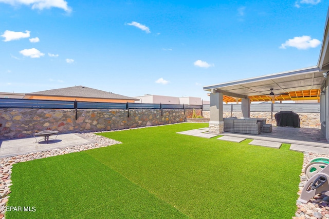 view of yard with a patio area and ceiling fan