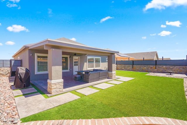 back of house with ceiling fan, a yard, outdoor lounge area, and a patio