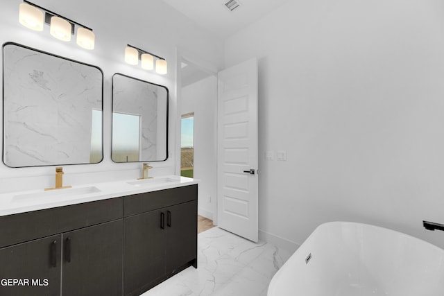 bathroom featuring dual bowl vanity, a bath, and tile patterned floors