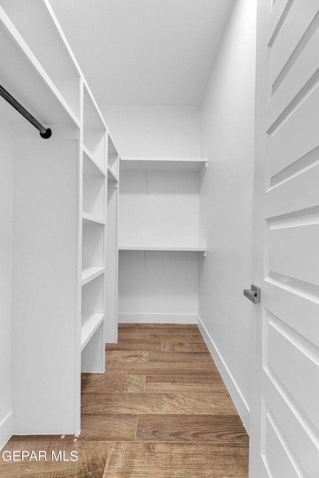 spacious closet with light hardwood / wood-style flooring