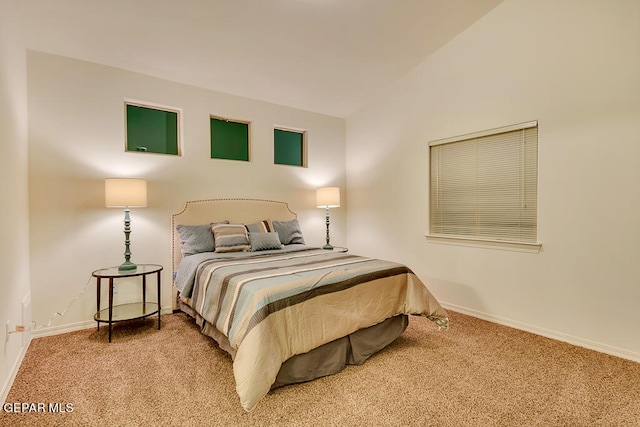 carpeted bedroom with lofted ceiling