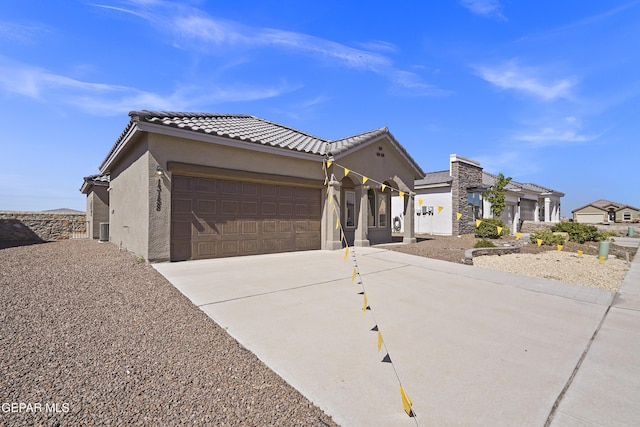 13158 Ludlow Ln, El Paso, TX 79928 - view of front of house featuring stucco siding, a garage, driveway, and a tile roof