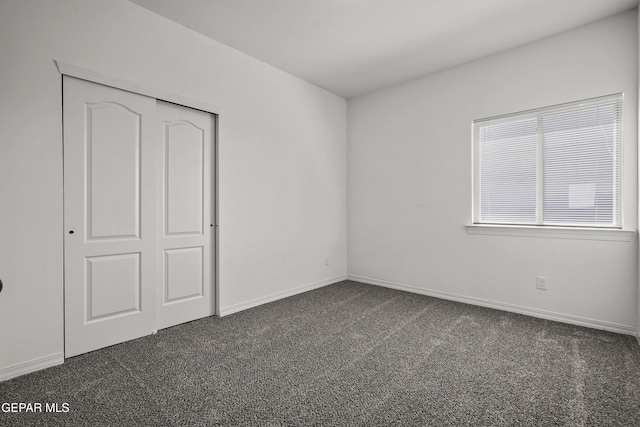 13158 Ludlow Ln, El Paso, TX 79928 - unfurnished bedroom featuring dark colored carpet and a closet