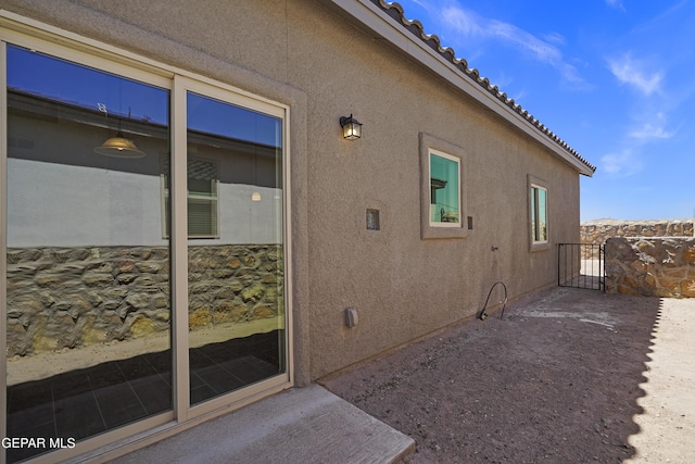 13158 Ludlow Ln, El Paso, TX 79928 - view of home's exterior featuring stucco siding, a gate, and a tiled roof