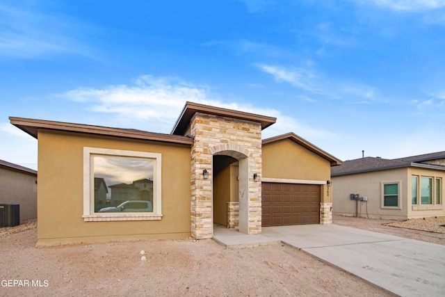 view of front of home with cooling unit and a garage