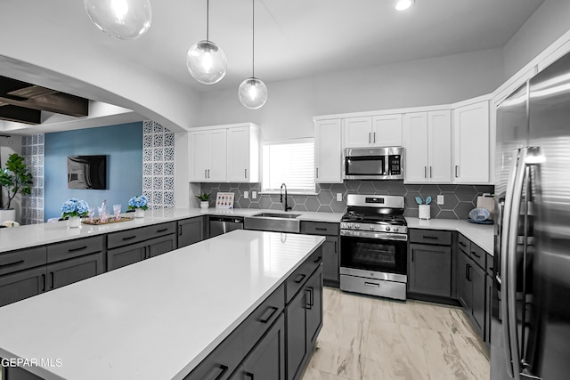 kitchen featuring backsplash, stainless steel appliances, white cabinets, and sink