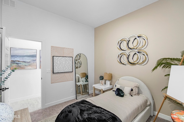 bedroom featuring light colored carpet