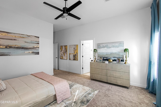 bedroom featuring light carpet and ceiling fan