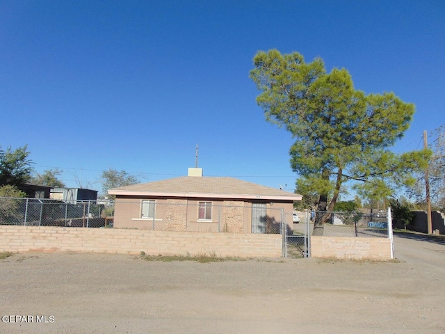 view of front facade featuring a fenced front yard and a chimney