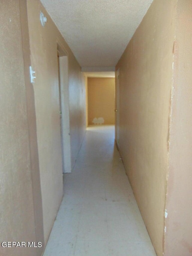 corridor featuring a textured ceiling