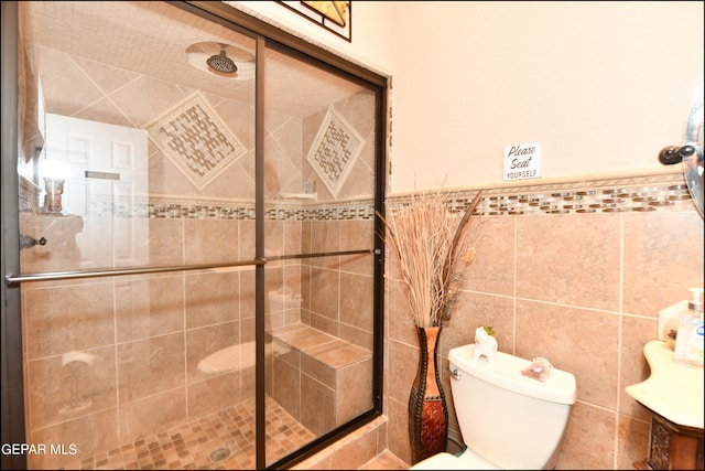 bathroom with tile walls, toilet, and walk in shower