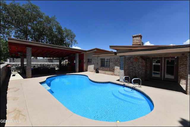 view of swimming pool featuring a fenced in pool and a patio